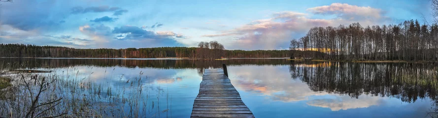 Fototapete Blauer Himmel Panorama-Landschaft. Holzsteg am See bei Sonnenuntergang, Wolkenreflexion im Wasser.