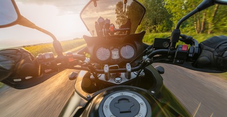 Man driving his motorcycle on asphalt country road