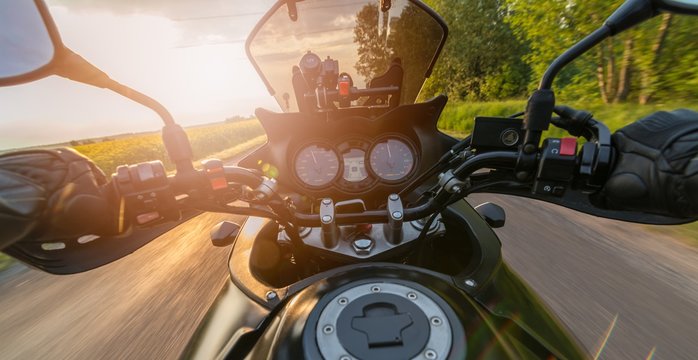 Fototapeta Man driving his motorcycle on asphalt country road