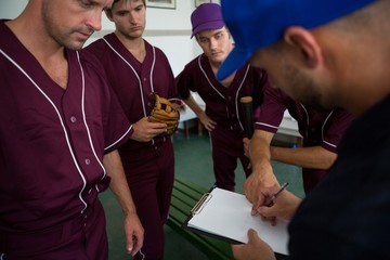 Close up of baseball team planning with coach