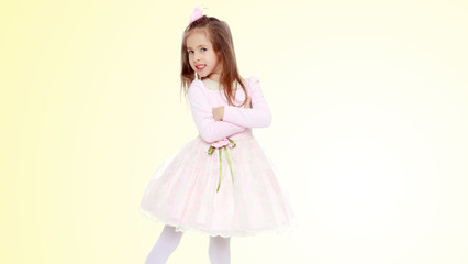 Naklejka premium Elegant little girl in a pink dress.