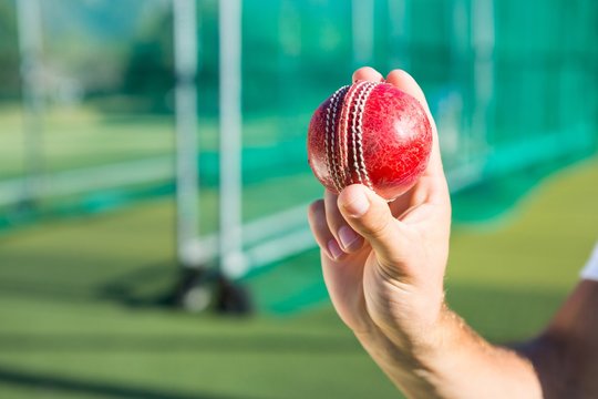Close up of person holding cricket ball