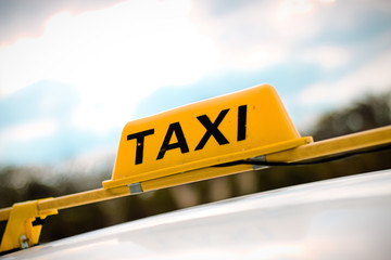 A taxi sign with blurred background