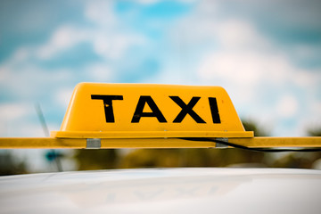 A taxi sign with blurred background