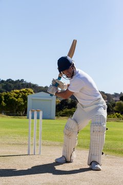 Determined cricketer playing on field