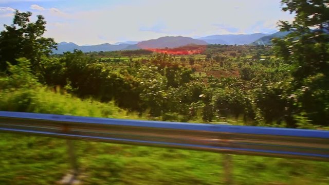 Camera Closely Moves by Metal Barrier against Rural Landscape