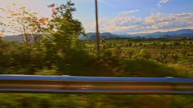 Camera Closely Moves by Metal Barrier against Rural Landscape