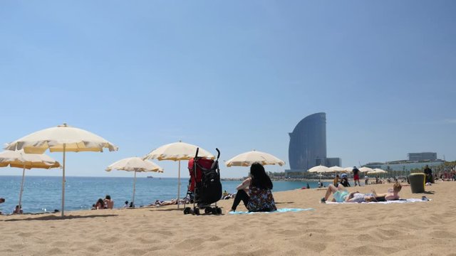 Tourists relaxing on Barcelona beach
