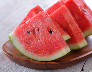 water melon in wood plate on table