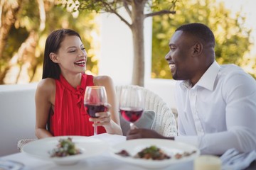Romantic couple toasting their wine glasses