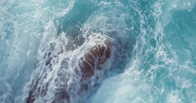 Aerial view of waves crashing against the rocks in Sardinia