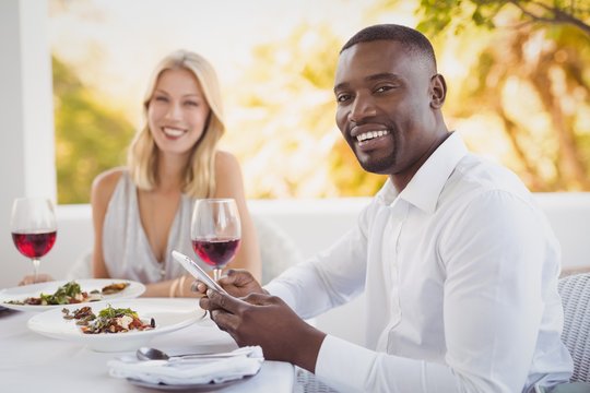 Man Ignoring Bored Woman While Using Mobile Phone