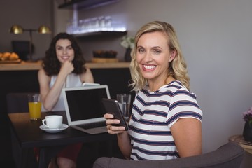Portrait of young woman using mobile phone
