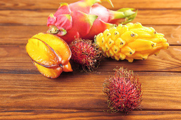 Tasty exotic fruits on wooden background