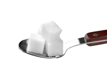 Sugar cubes in spoon on white background