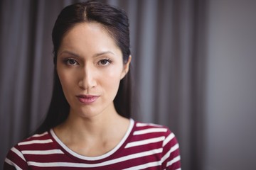 Young woman standing at home