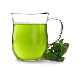 Cup of tea with mint leaves on white background