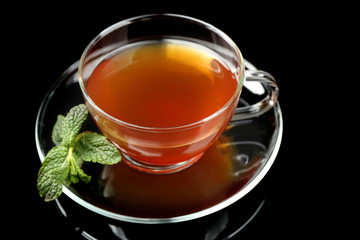 Cup of tea with mint leaves on dark background © Africa Studio