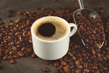 Cup of coffee and scoop on beans