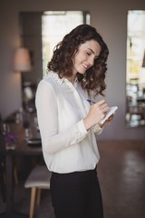 Smiling waitress writing order on notepad