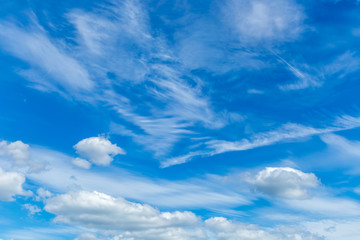 Blue sky with sculpted clouds on the background