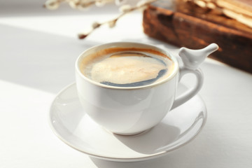 Ceramic cup with coffee on white window sill