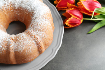 Plate with delicious freshly baked cake on table