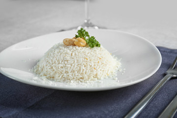 White plate with tasty coconut rice on table