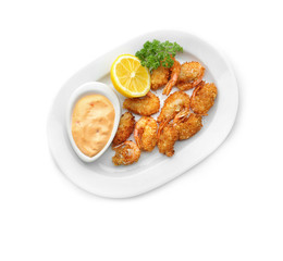 Plate with delicious coconut shrimps on white background
