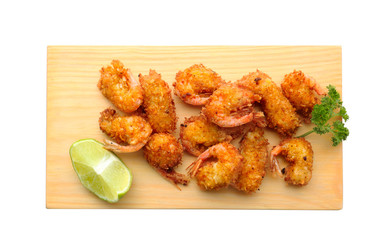 Wooden board with delicious coconut shrimps on white background