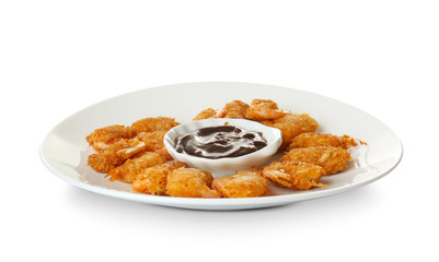 Plate with delicious coconut shrimps on white background
