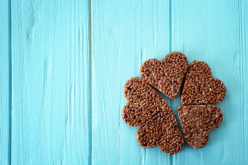 Heart shaped crispy dessert on wooden background, top view