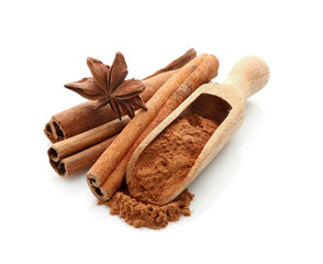 Cinnamon sticks and powder with anise star isolated on white