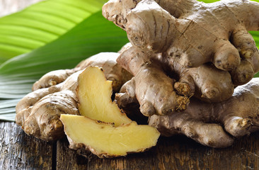 Fresh ginger root on wooden background