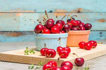 Red ripe cherries in ceramic bowls
