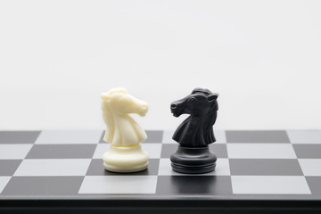face to face black and white chess figure on table with copy space for strategy business; chicanery; slyness; survival; foeman; fighting; planing concept.