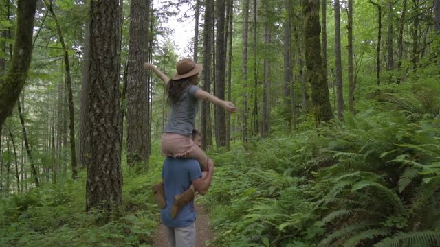 Man Gives Girlfriend A Shoulder Ride Through The Forest, He Twirls Her Around In Circle