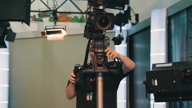 TV operator install video camera for shooting in studio