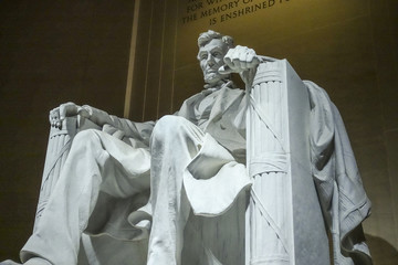 The statue of Abraham Lincoln sitting in a chair at Lincoln Memorial in Washington