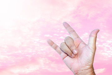 Abstract pink beautiful sky with fluffy clouds and The right-hand show love signal, for background, Valentine day