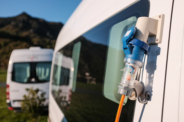 Campervan with 380v electricity plug in a camp