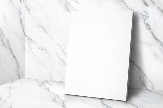 Blank white poster canvas in white glossy marble floor leaning at wall,Mock up template for display or montage of design or text,Business presentation