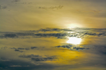 The abstract formation and texture of the clouds over and around the sun. Above the Gulf of Mexico in florida