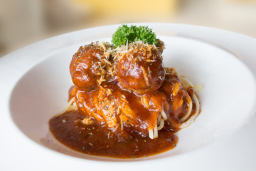Spaghetti with porkballs in tomato sauce. Parmesan and vegetables.  Italian style.