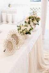 Wedding ceremony decoration in the restaurant. Decoration of wedding table with tender white textile