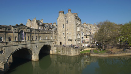 many tourists are enjoying nice weather in summer at the ancient landmark bridge n bath city in England