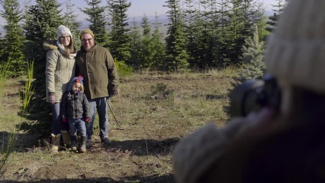 Photographer Takes Family's Portrait At Christmas Tree Farm 
