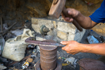 Blacksmith makes a traditional rural knife in Cao Bang province, Vietnam