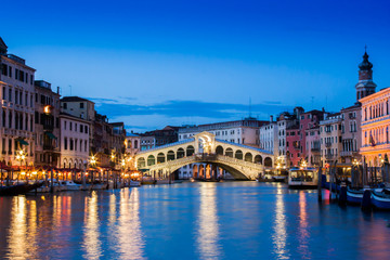 Ponte Rialto and gondola at sunset in Venice, Italy