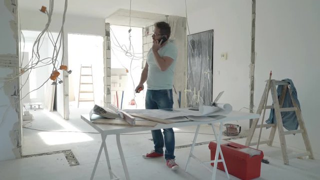 Busy male architect working at new home, timelapse
